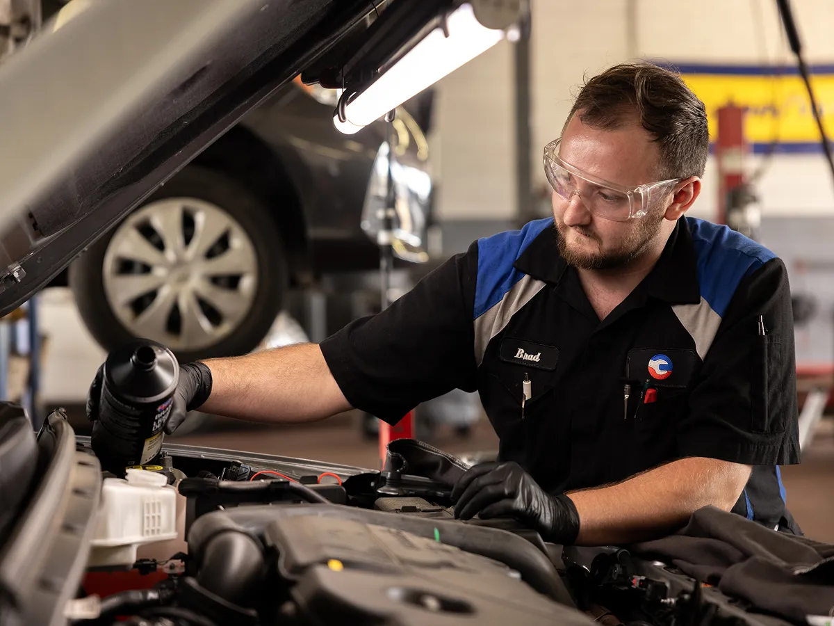 man repairing car