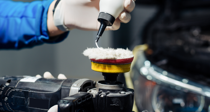 An employee applying polish to a rotary brush