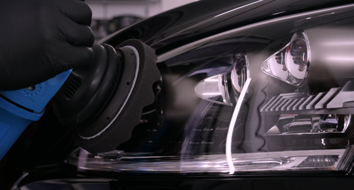 Glamor shot of a shiny headlight finishing up being polished