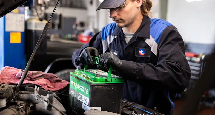 Tire Source employee installing a car battery