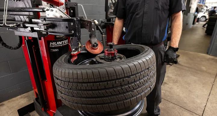 Tire Source tech performing a tire balancing