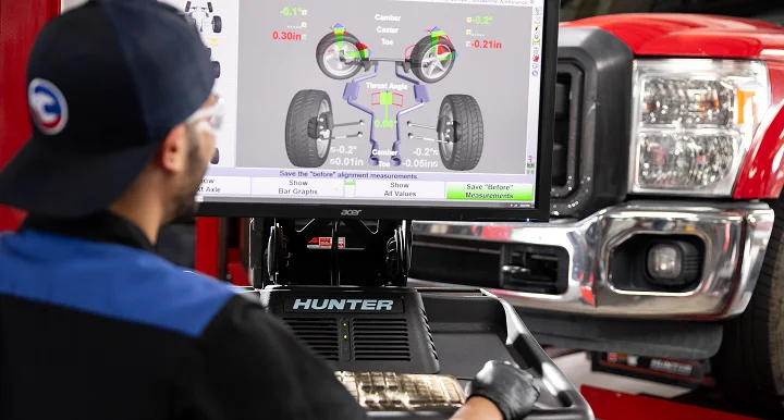 man looking at wheel alignment