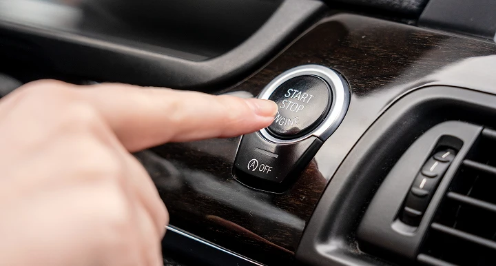person interacting with car dash